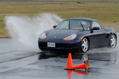 Photo of Steve Garstang's Boxster kicking up a spray of water